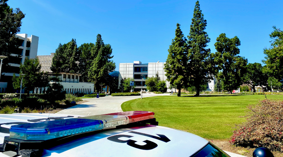 CSUF lawn with police vehicle at the bottom
